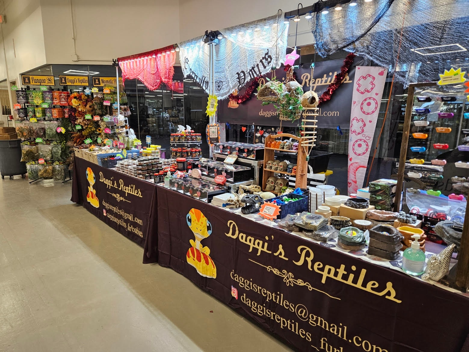 Daggi's Reptiles booth at a reptile expo — table display with products and branding